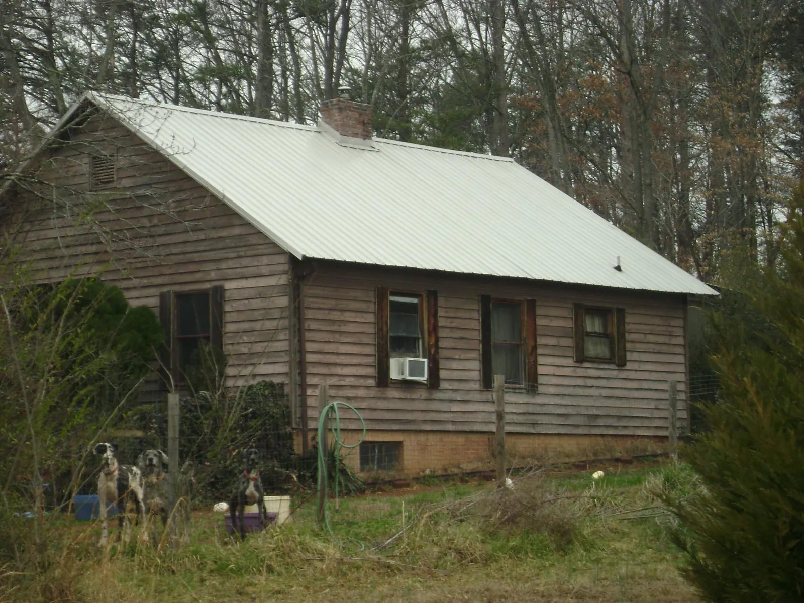 White metal roof on an old wood sided farmhouse, from a Asphalt Shingle Roof Repair job in Overland Park